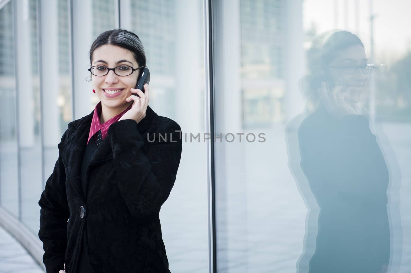 smiling business girl on the phone by peus