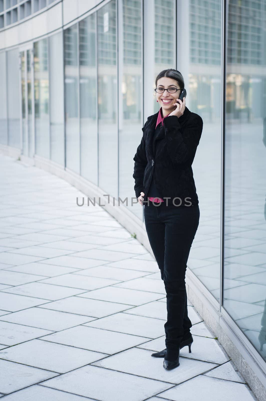 smiling business girl on the phone by peus