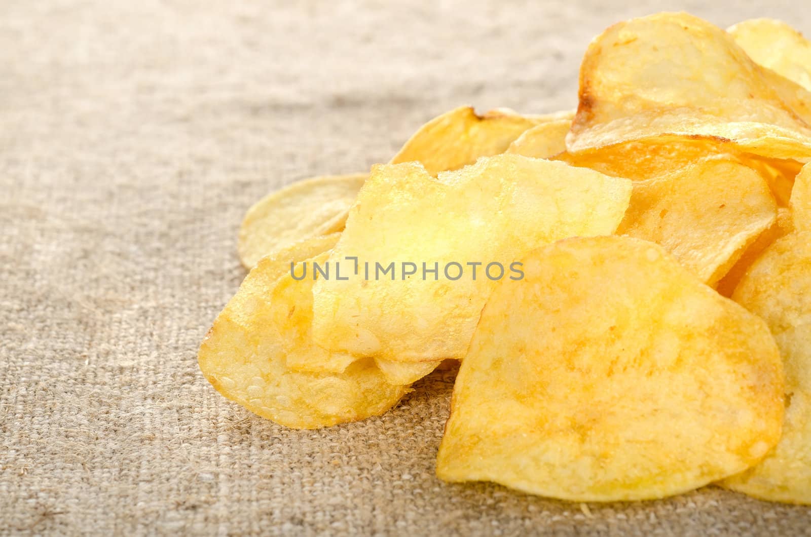 Potato chips on a old brown canvas