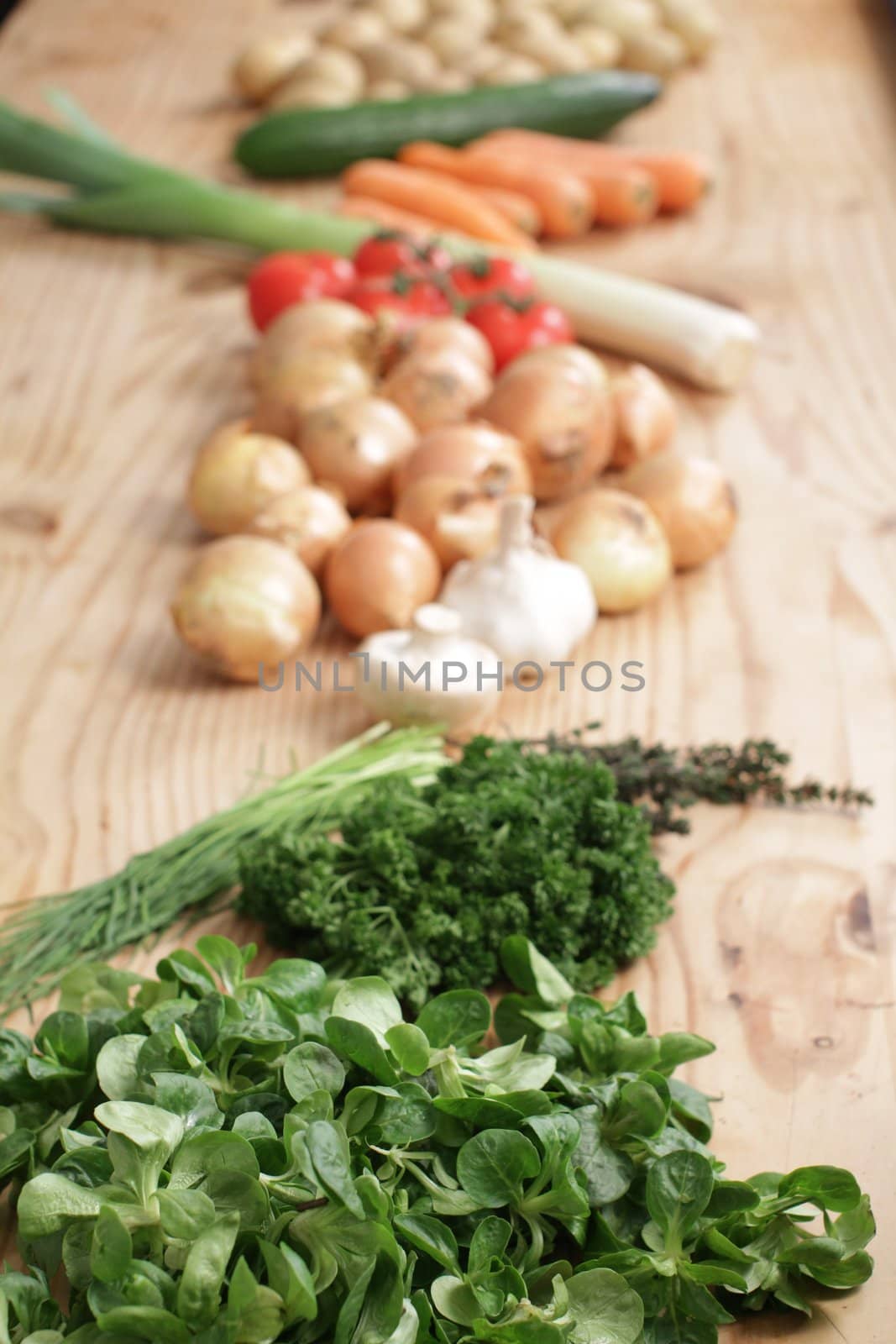 many different vegetables on a wooden table