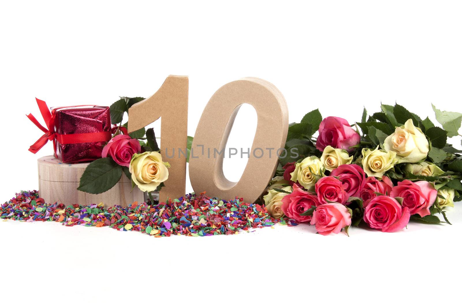 Number of age in a colorful studio setting with fresh roses on a bottom of confetti