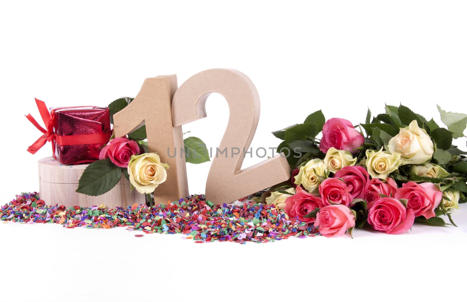 Number of age in a colorful studio setting with fresh roses on a bottom of confetti