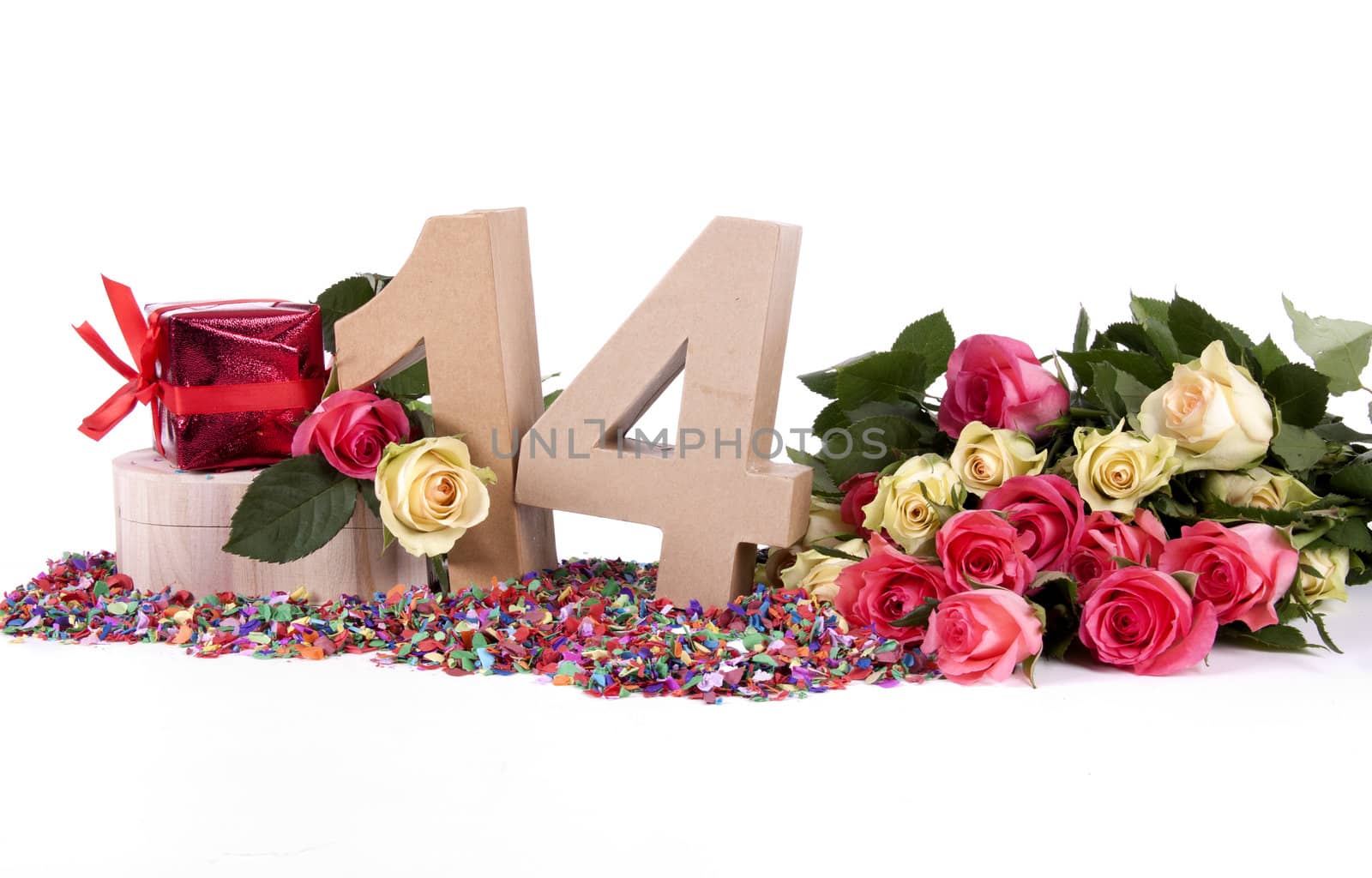 Number of age in a colorful studio setting with fresh roses on a bottom of confetti