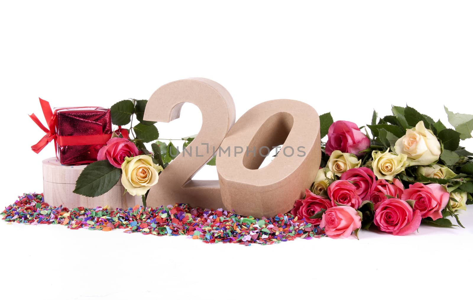 Number of age in a colorful studio setting with fresh roses on a bottom of confetti