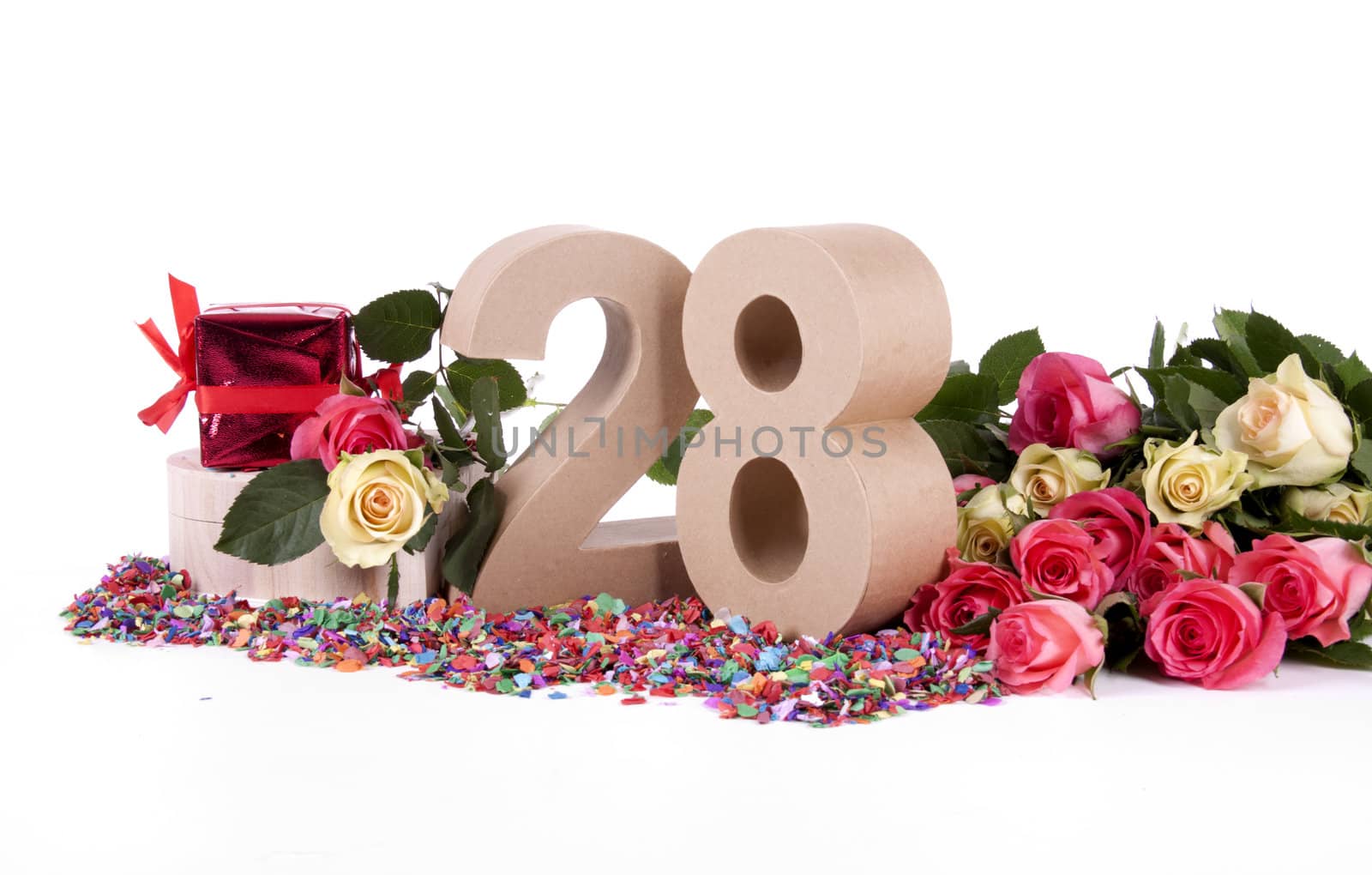 Number of age in a colorful studio setting with fresh roses on a bottom of confetti