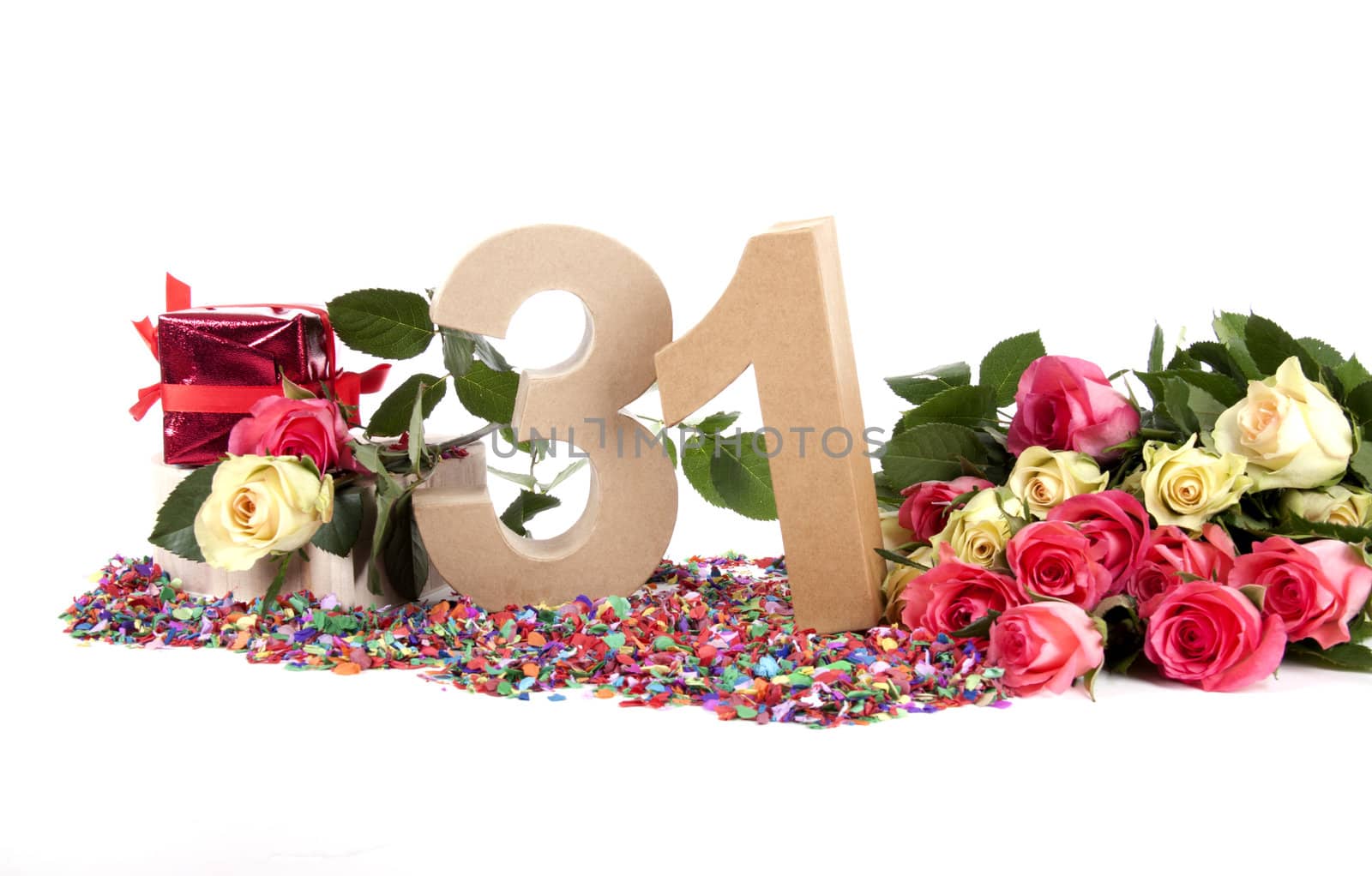 Number of age in a colorful studio setting with fresh roses on a bottom of confetti