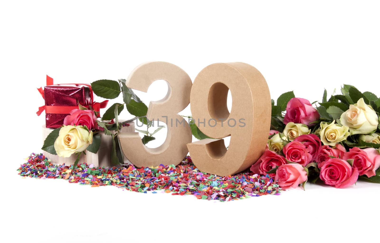 Number of age in a colorful studio setting with fresh roses on a bottom of confetti