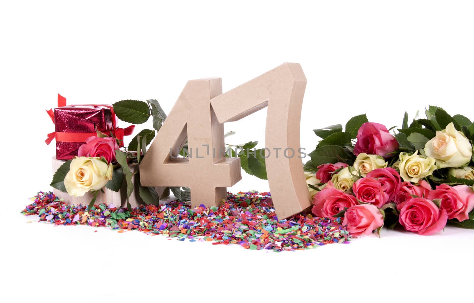 Number of age in a colorful studio setting with fresh roses on a bottom of confetti