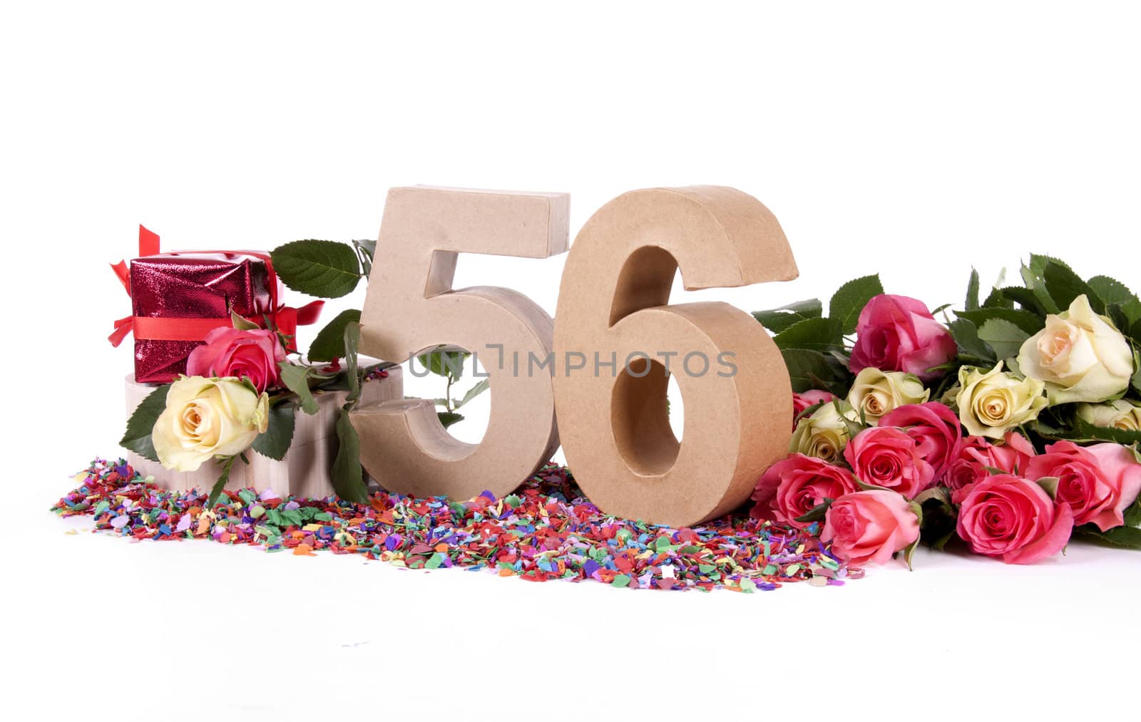 Number of age in a colorful studio setting with fresh roses on a bottom of confetti