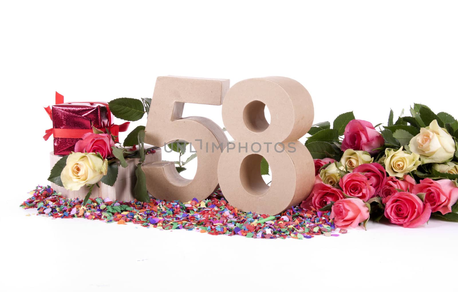 Number of age in a colorful studio setting with fresh roses on a bottom of confetti