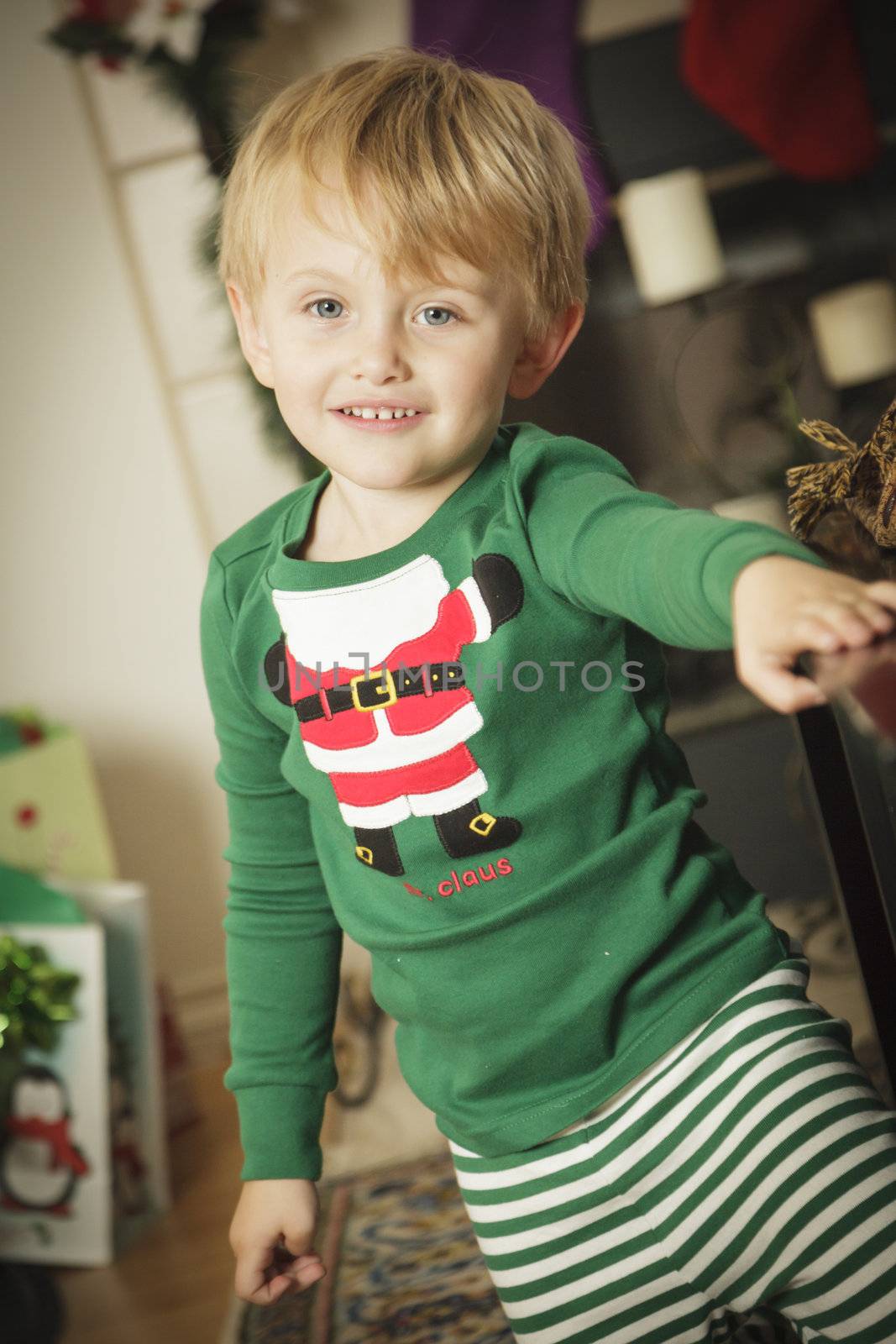 Cute Young Boy Enjoying Christmas Morning Near The Tree.