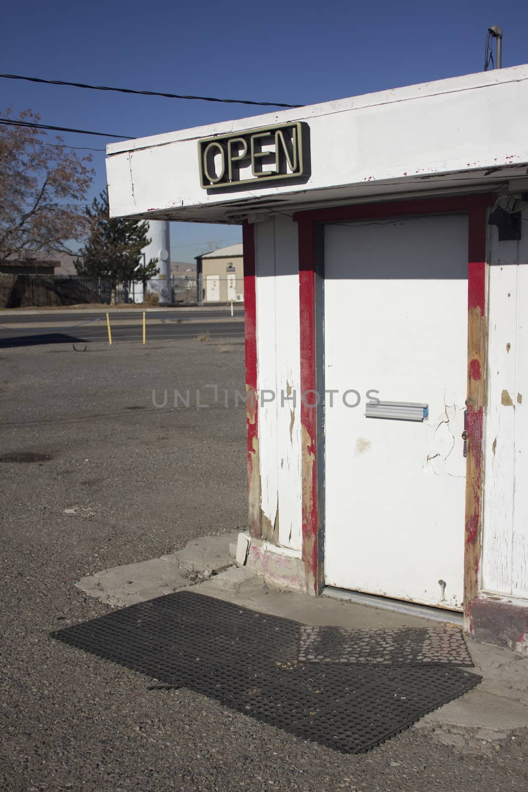 Door for a business with open neon sign by jeremywhat