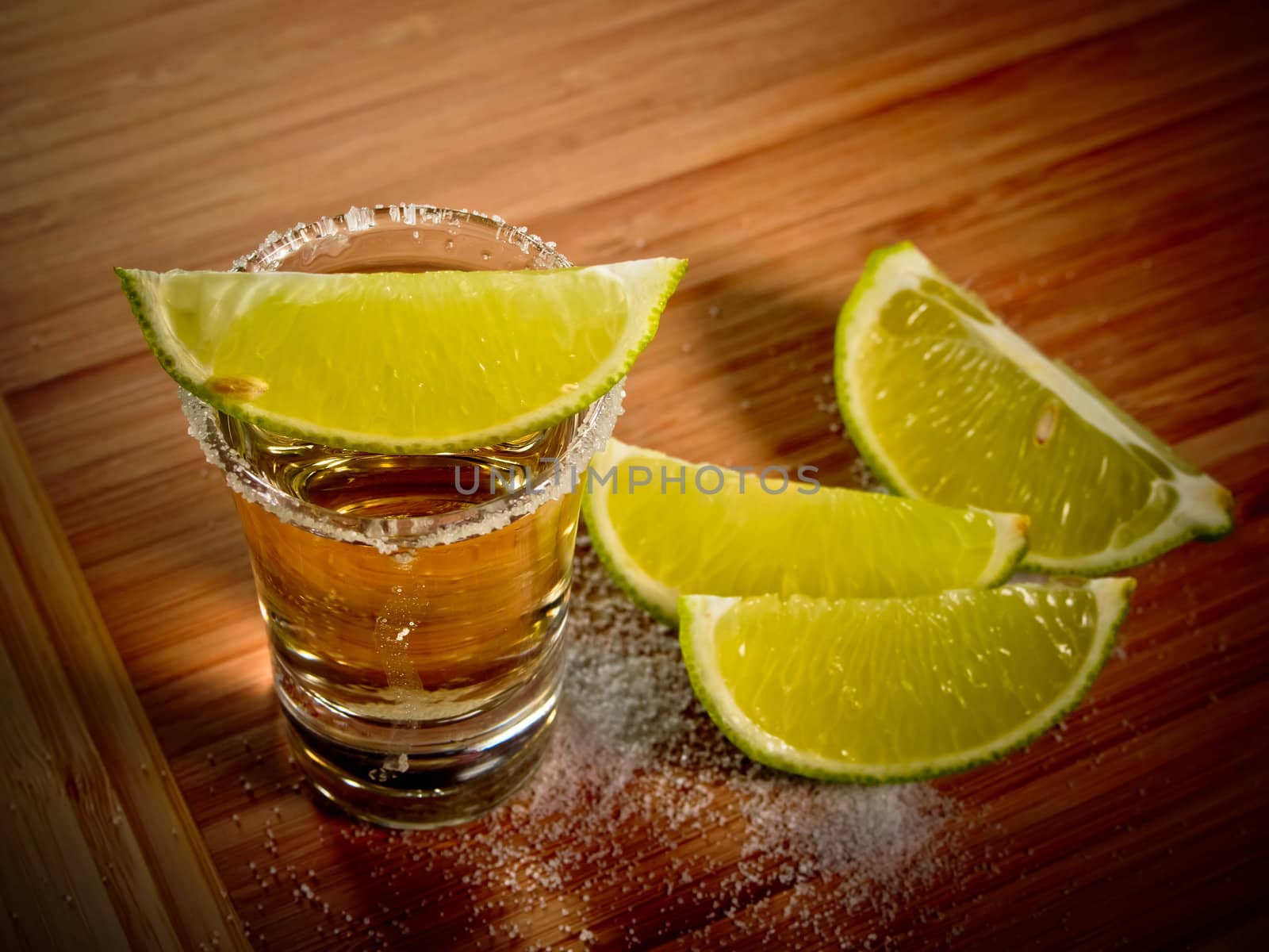Tequila shot with salt rim and lime wedges