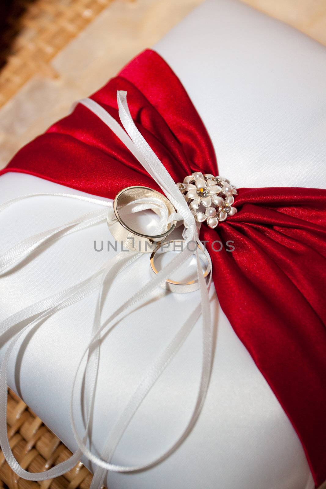 The ringbearer's pillow has the wedding rings attached and is ready to march down the aisle at a wedding day ceremony.