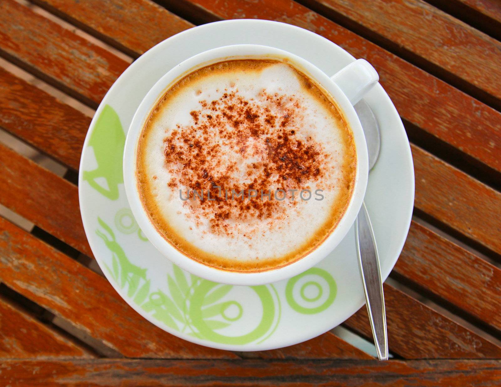 Coffee latte or cappuccino in a cup on wooden background by nuchylee