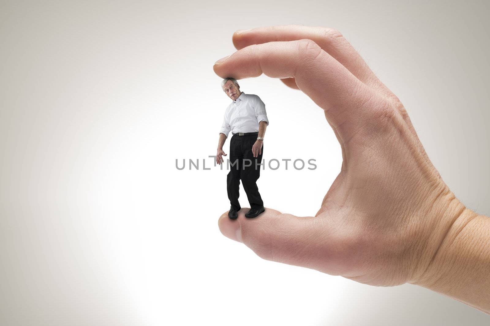 Conceptual creative shot of a man between fingers.