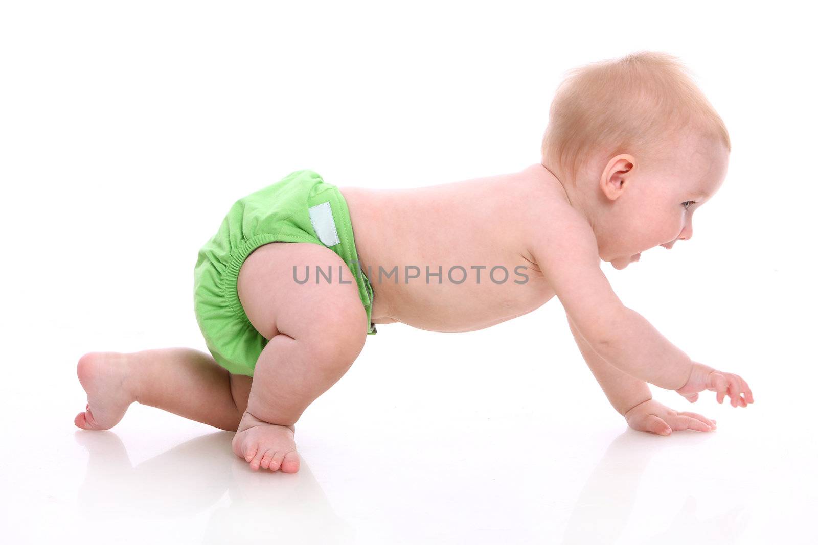 Cute little baby in green diapers smiling