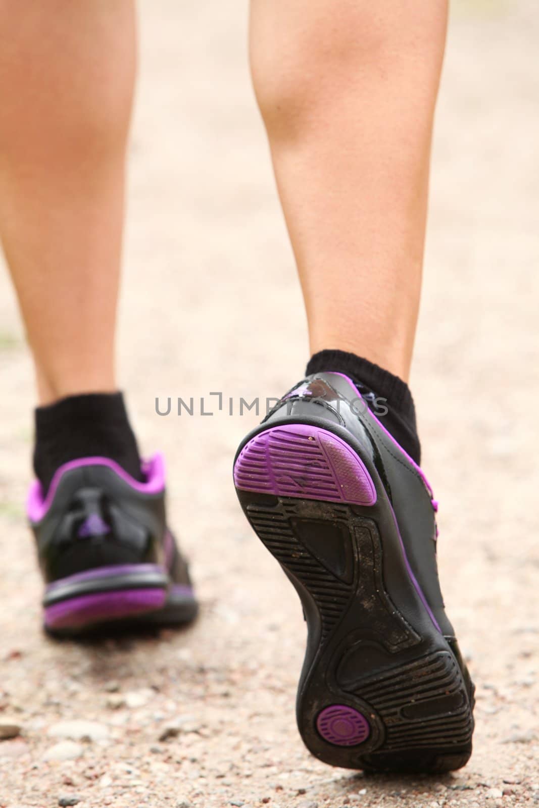 Close up of walking legs in shoes on the road