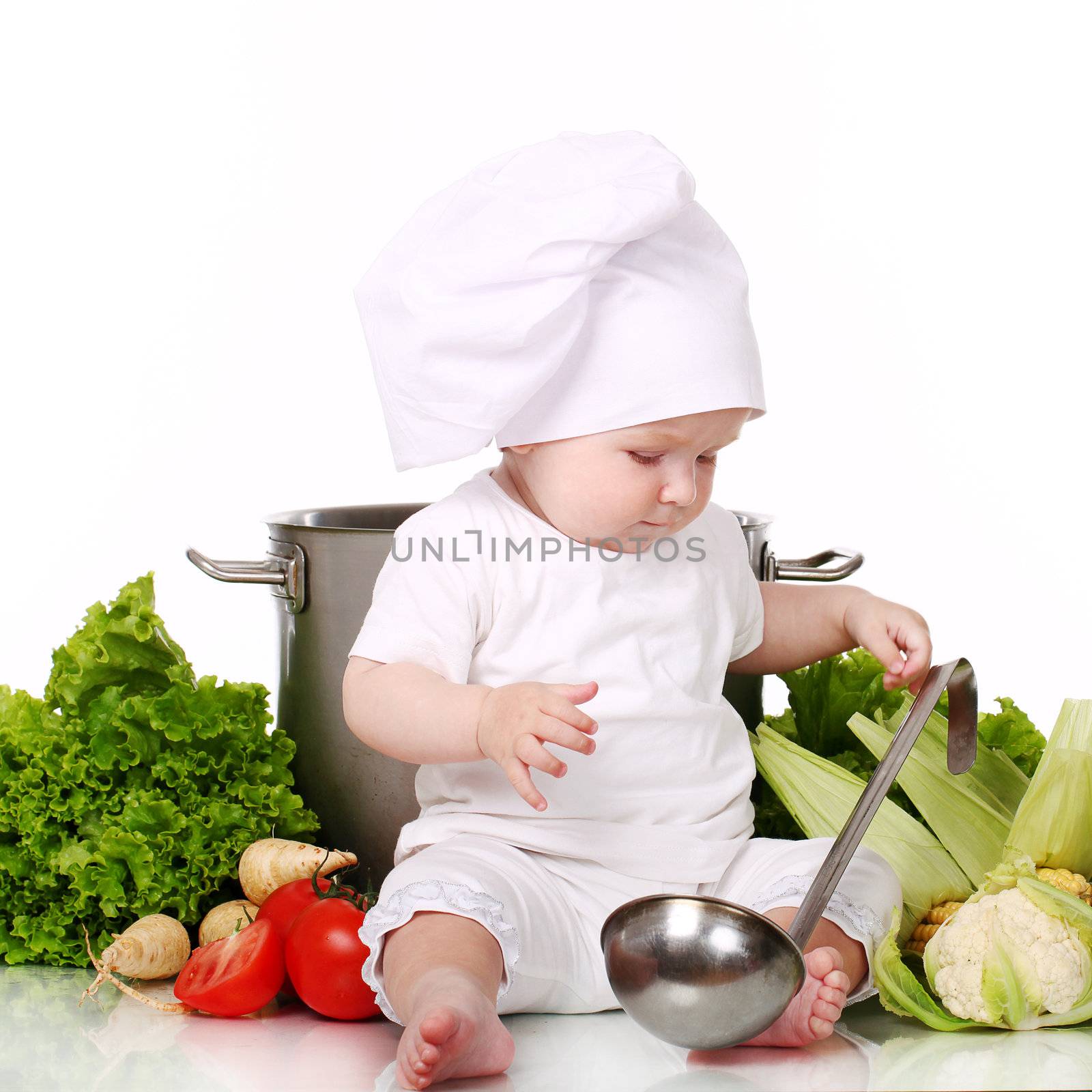 Baby cook with pan and vegetables isolated on a white