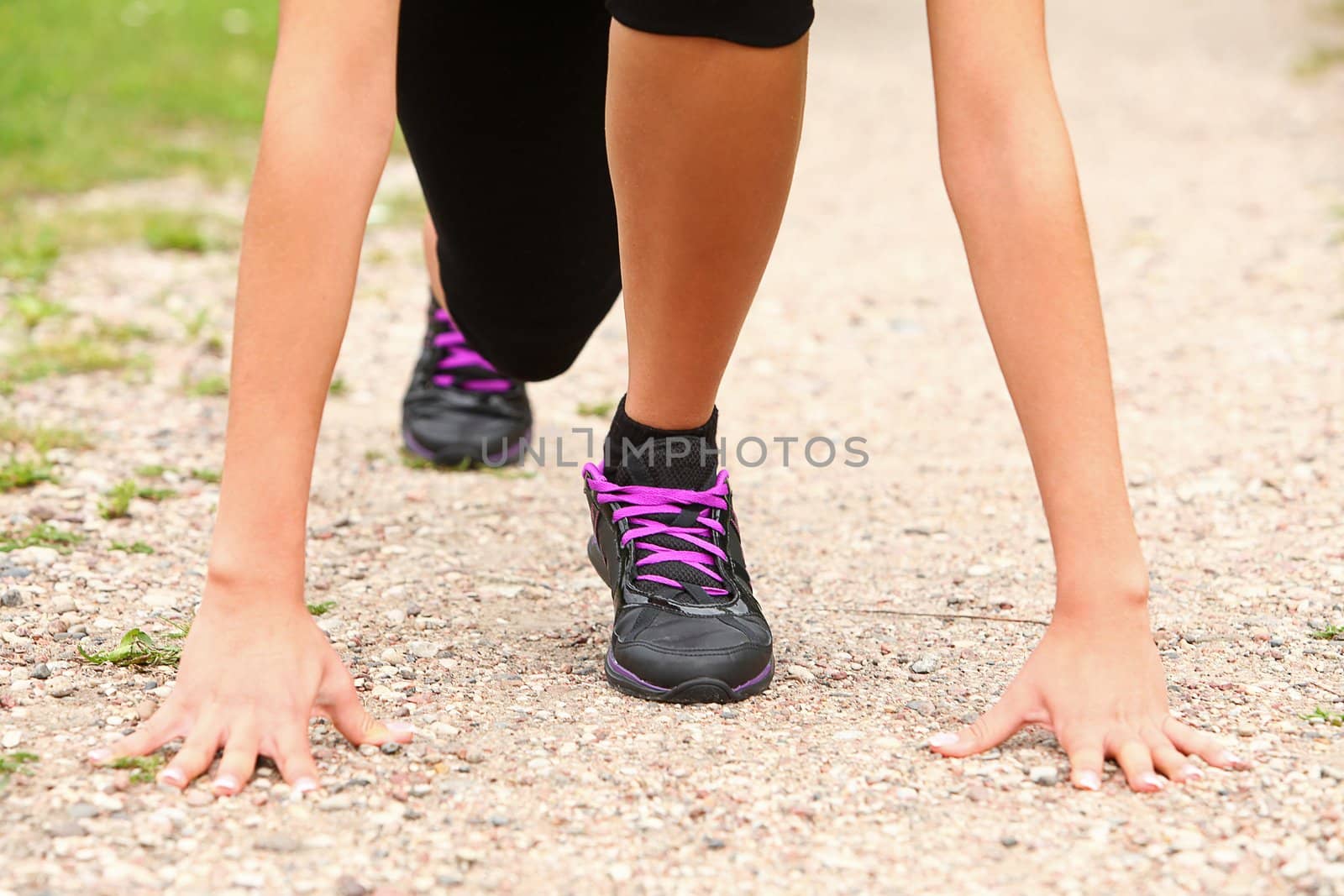 Sporty woman on the road ready for run close up