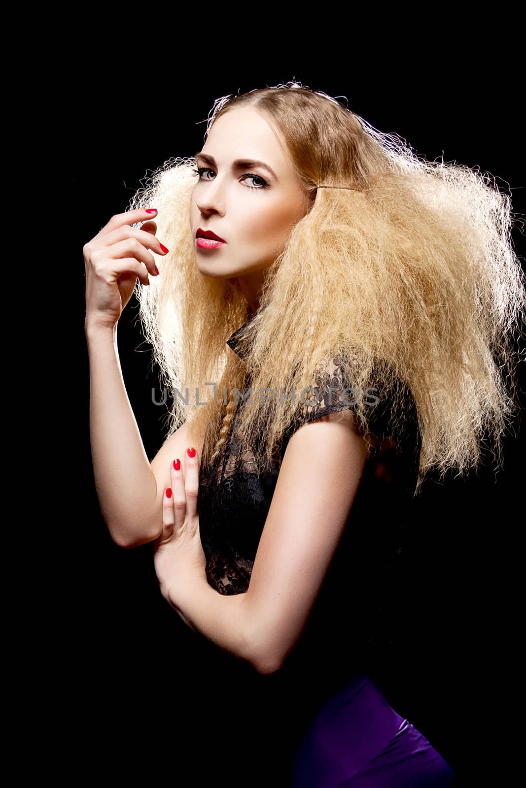 young pretty blonde woman with big hair and fashion isolated on black