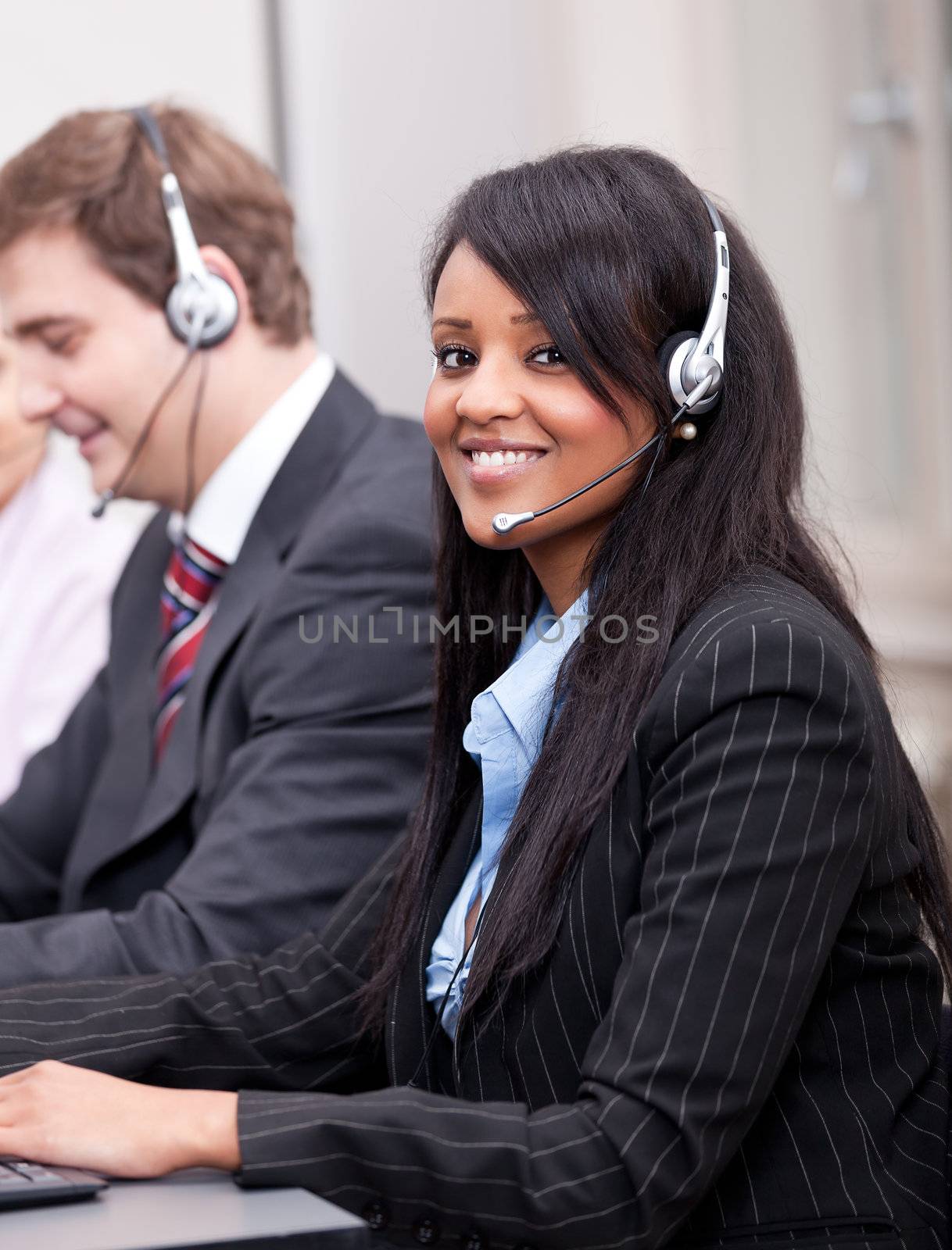 young african business woman talking with headset in callcenter