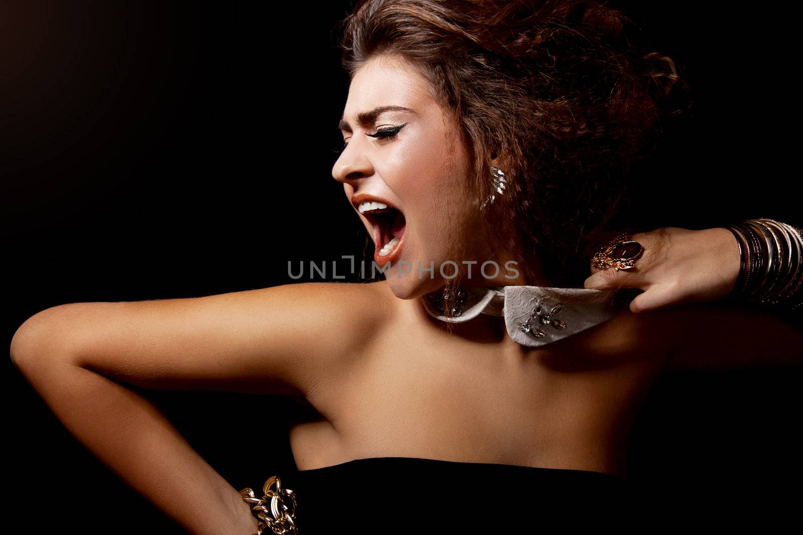 glamour elegant woman portrait with golden makeup on black shout scream