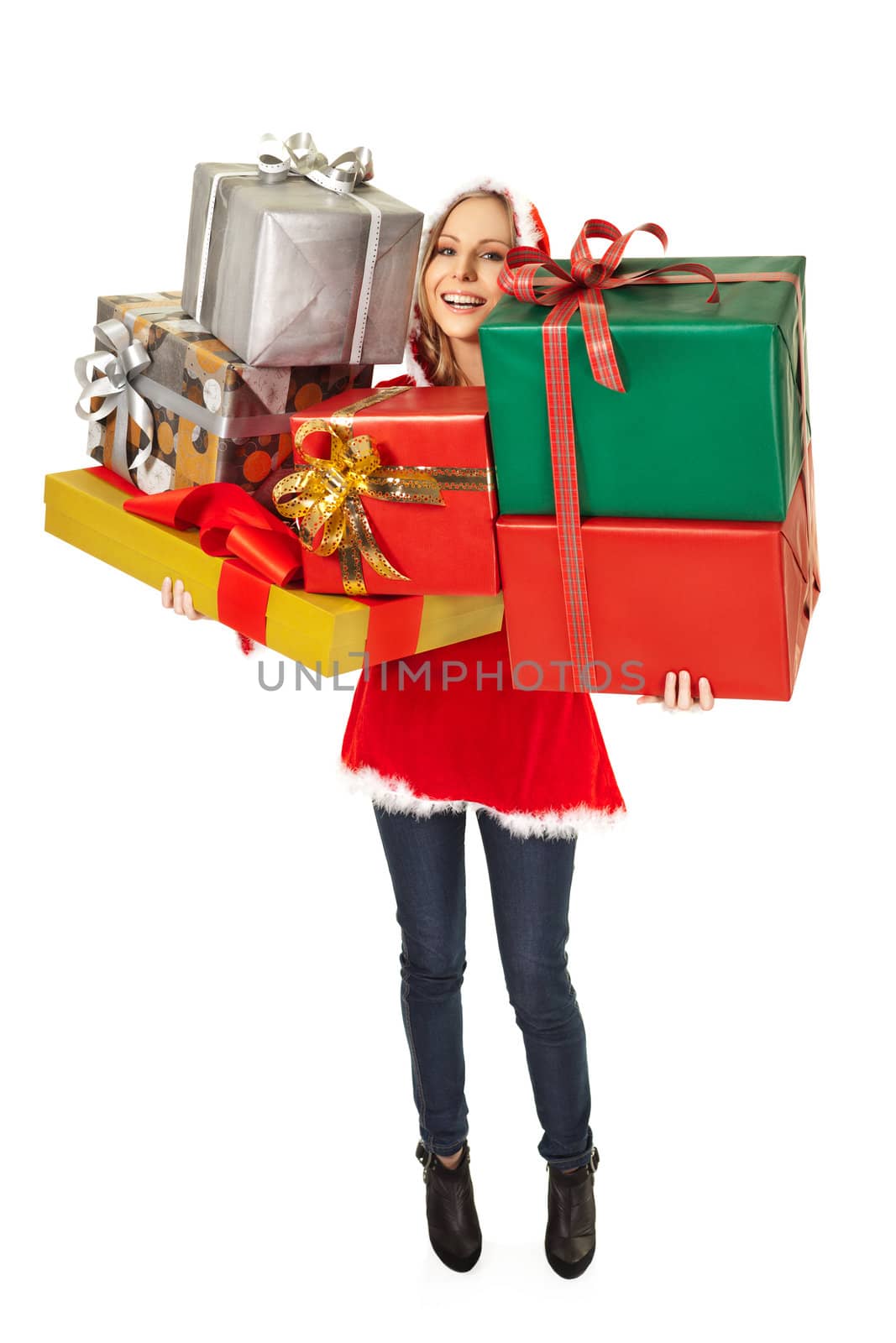 Smiling female with christmas costume standing with gift boxes on white background