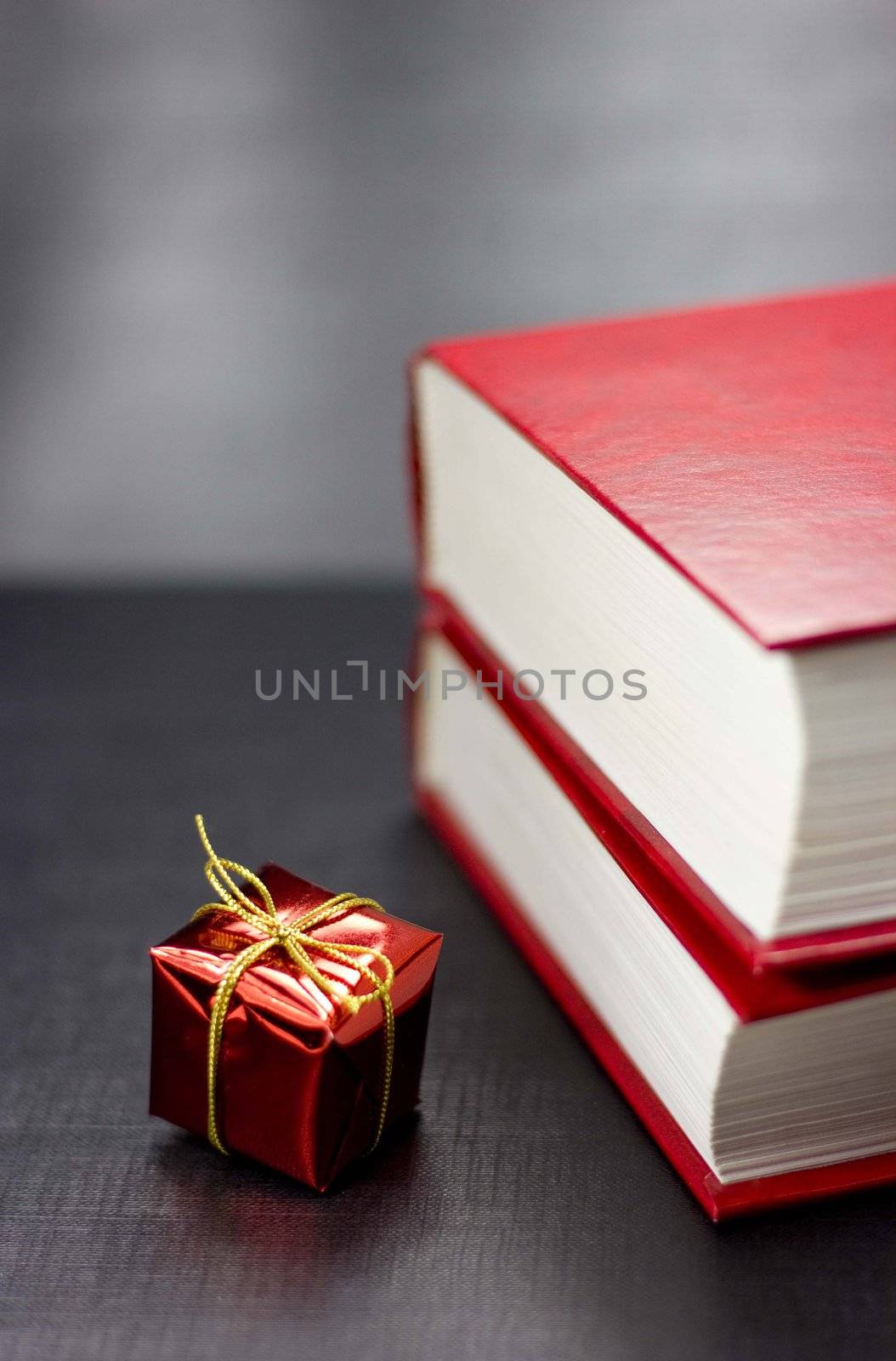 Two books and present on a black background by Kristina_Usoltseva