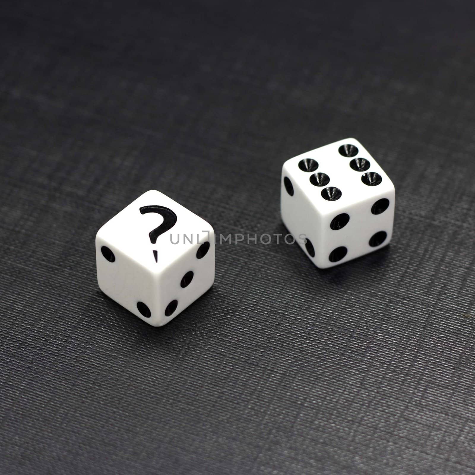 Two white dices on a black background