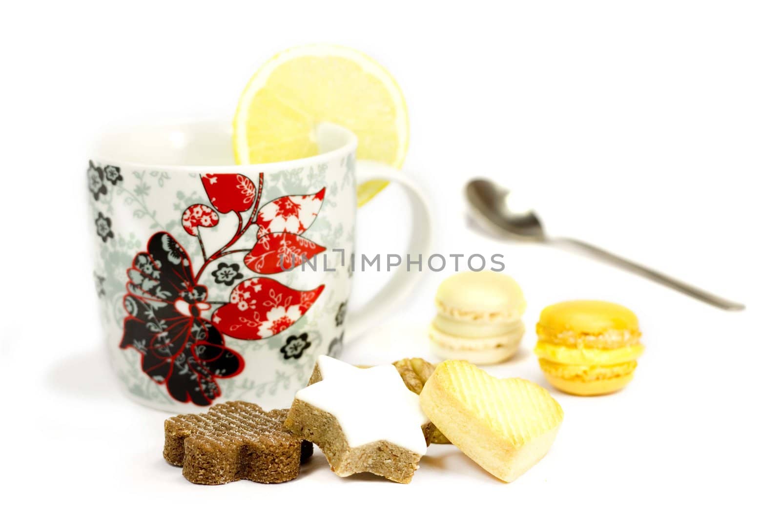 Cookies and mug with lemon on a white background