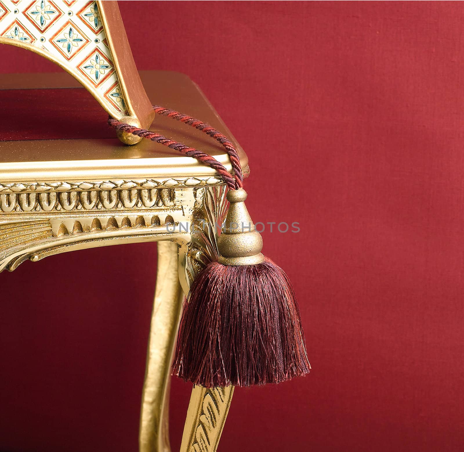 cute design of tassel on the golden chair