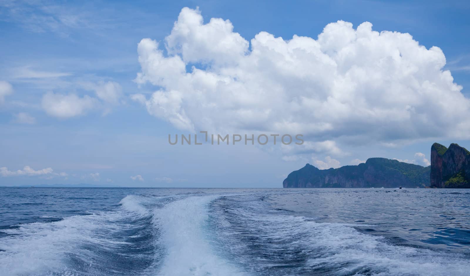 speedy boat prop wash, white wake on the blue ocean sea