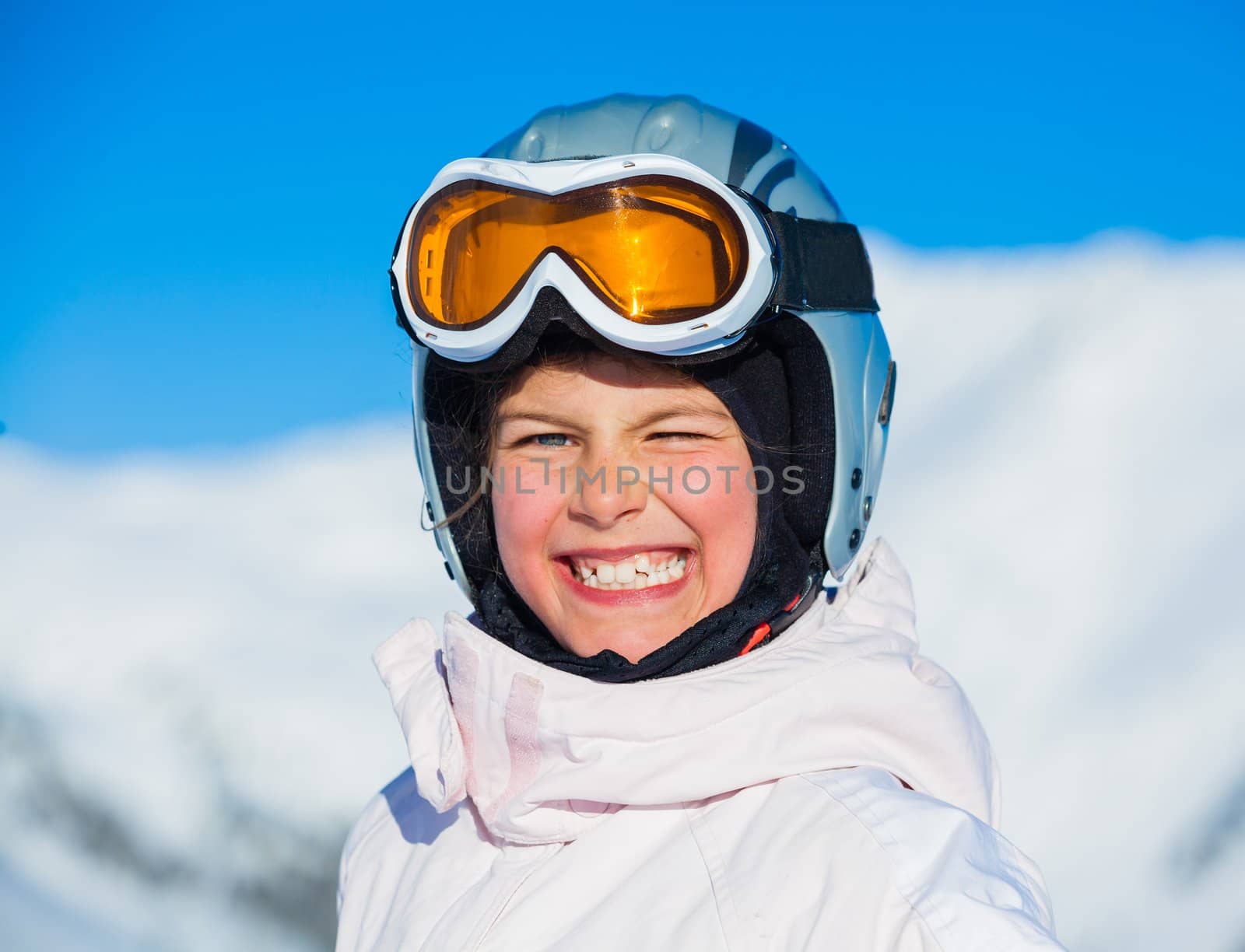 Portrait of young smiling girl a ski outfit at winter outdoor in the Zillertal Arena, Austria