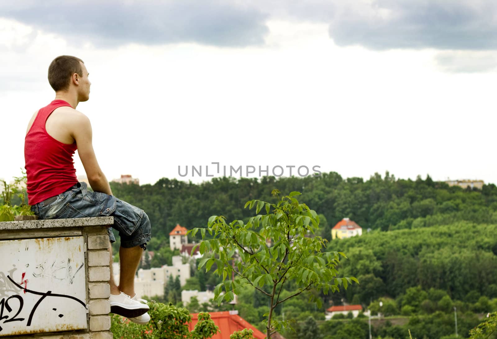 A guy sitting on a fence  by Kristina_Usoltseva