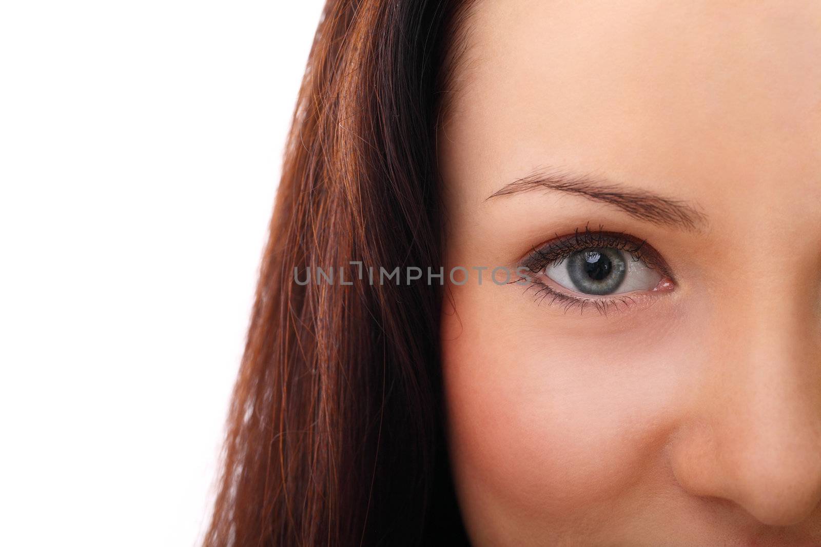 Beautiful brunette half shooted face close up over a white background