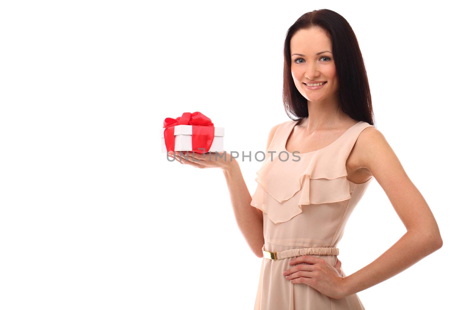 Beautiful young girl smiling and holding gift over a white background