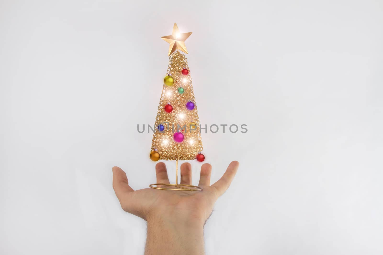 Christmas tree with toys and bright lights is on hand