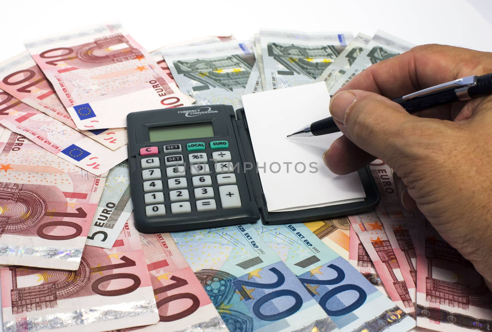 human hand with euro paper and calculator