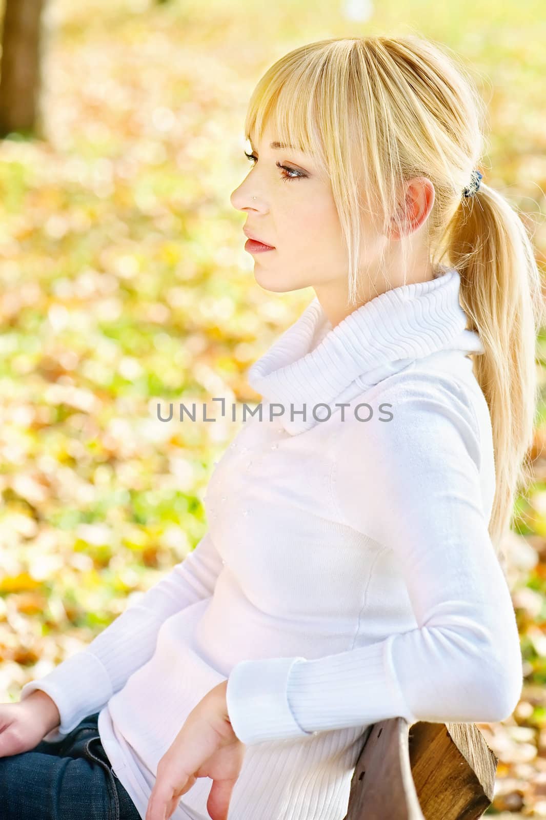 Young blond woman resting in park