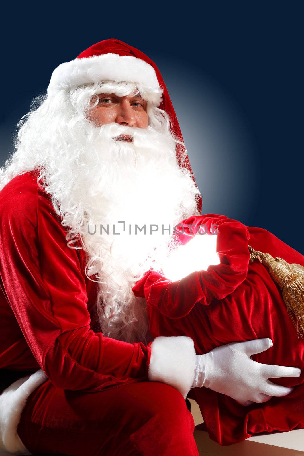 Santa Claus with his magic gift red bag full of presents