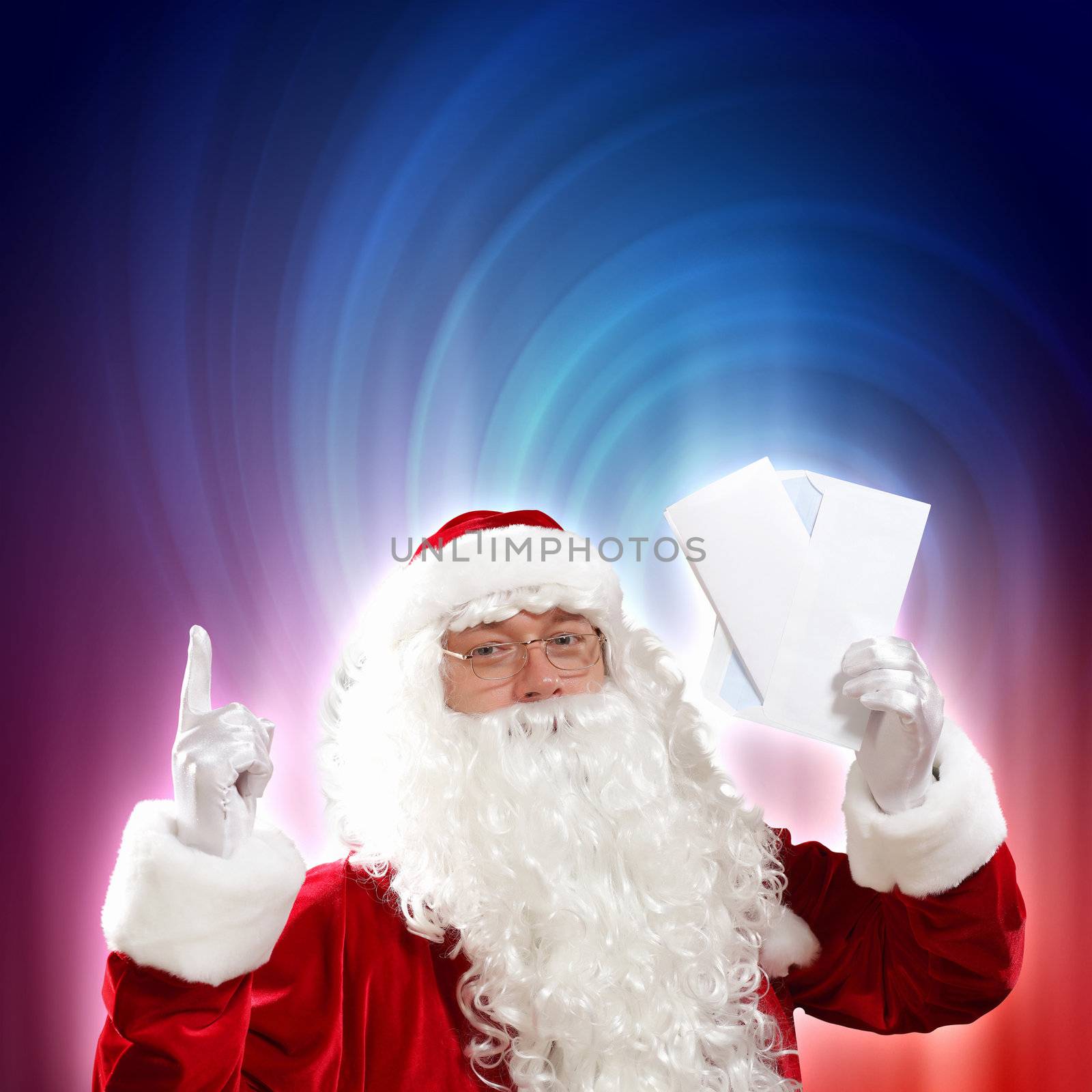Santa holding Christmas letters and looking at camera