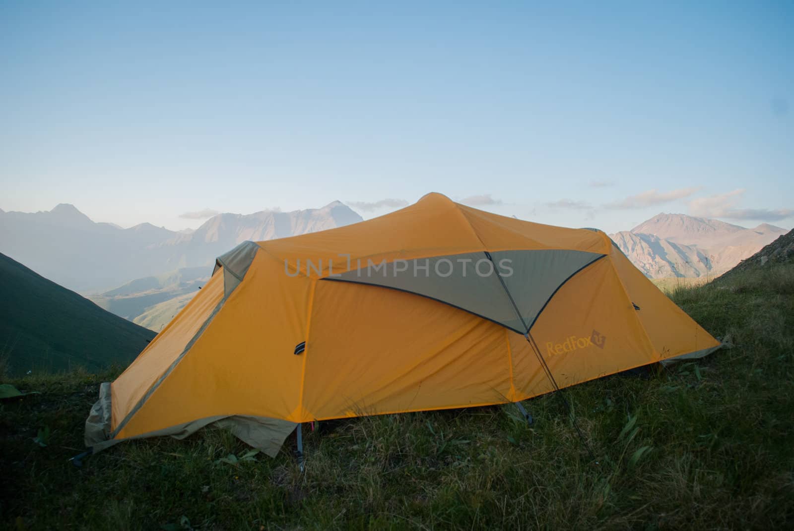 Orange tent in mountains in summer in South Ossetia
