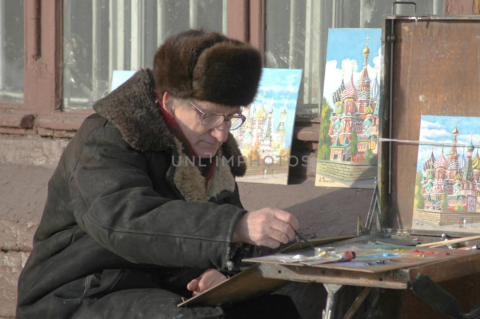 Moscow, Russia - January 2005. The freelancer artist  draws pictures for sale.