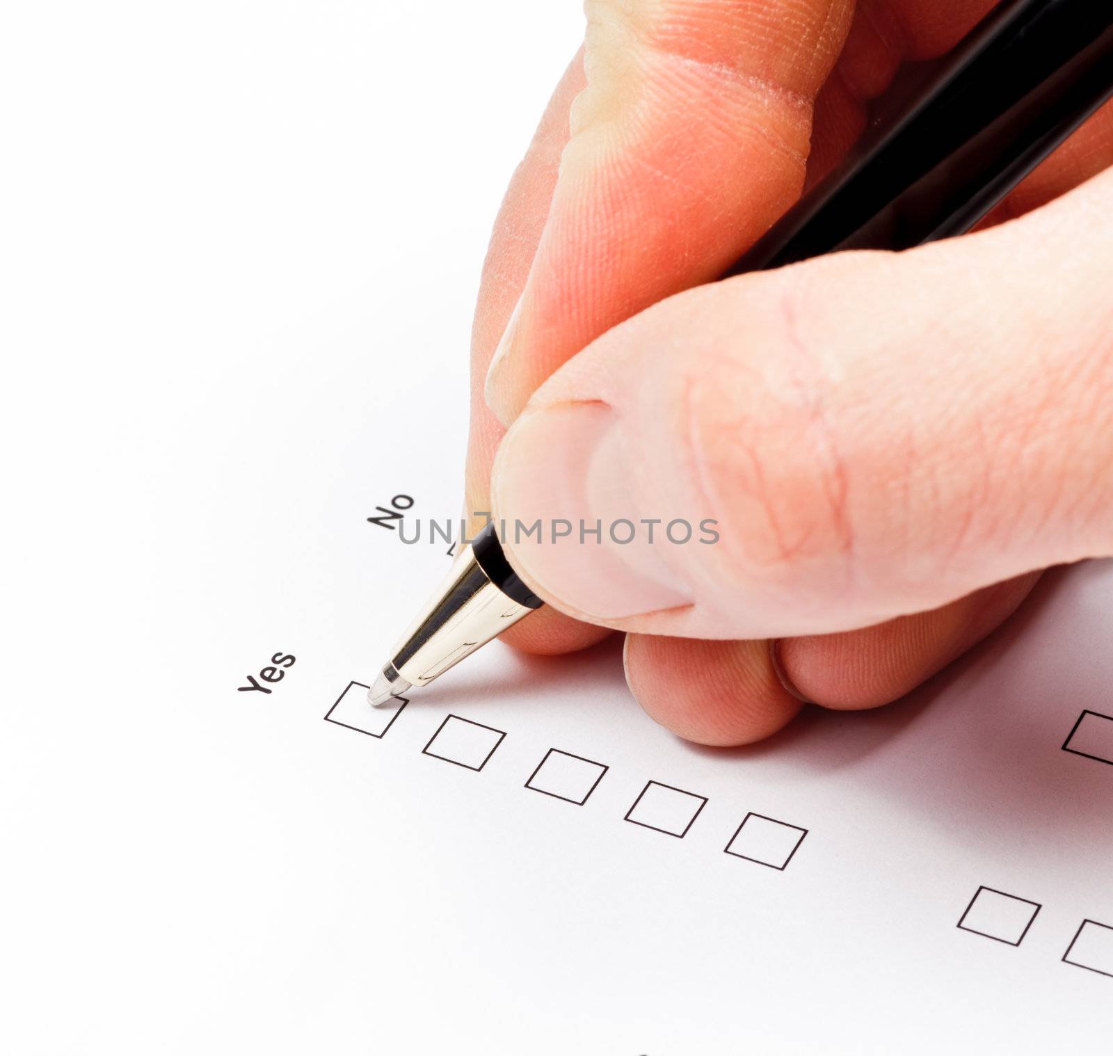 Hand with pen over blank check boxes in a form