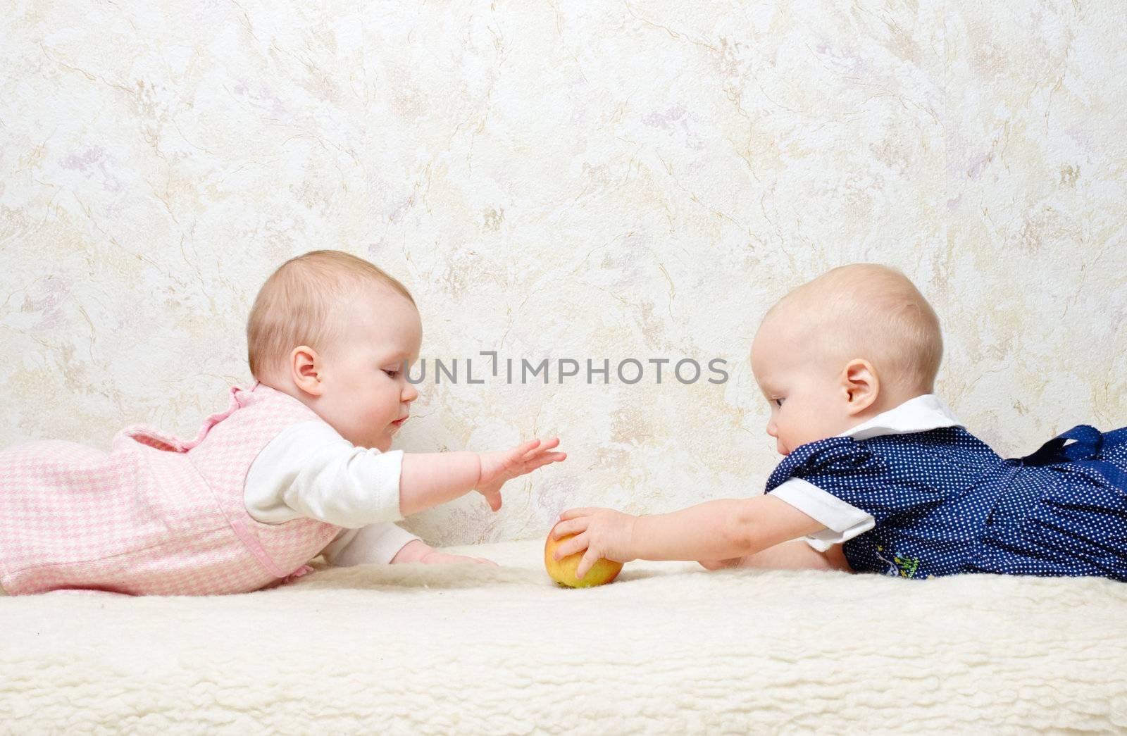 Two infants with apple