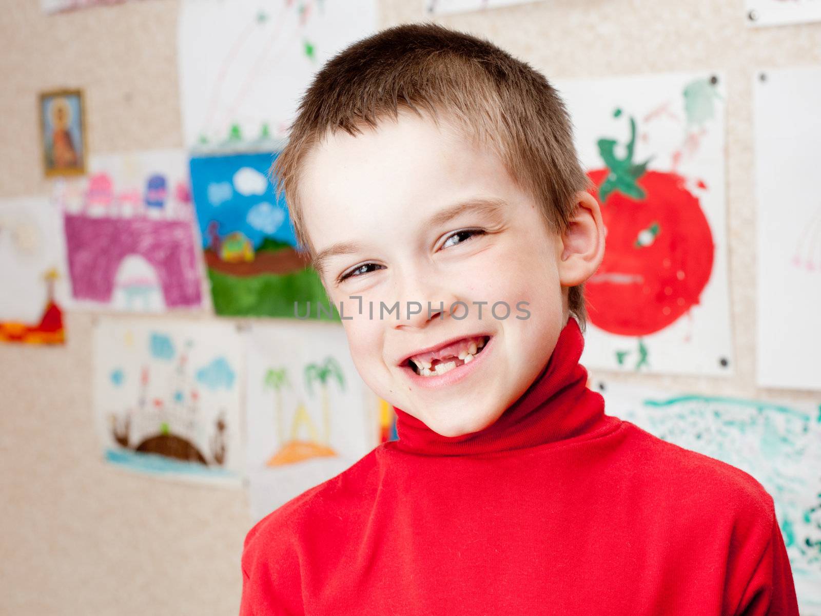 Smiling boy shows lost deciduous teeth