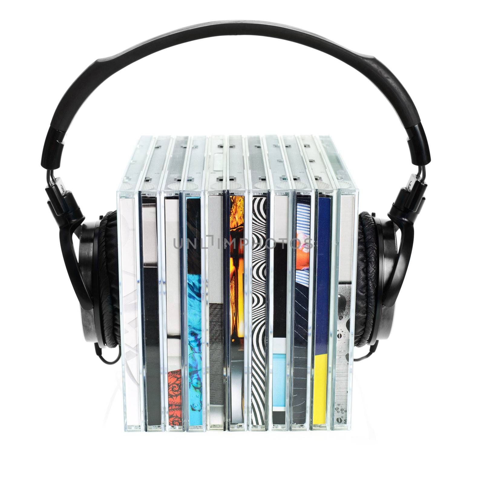 HI-Fi headphones on stack of CDs on white background