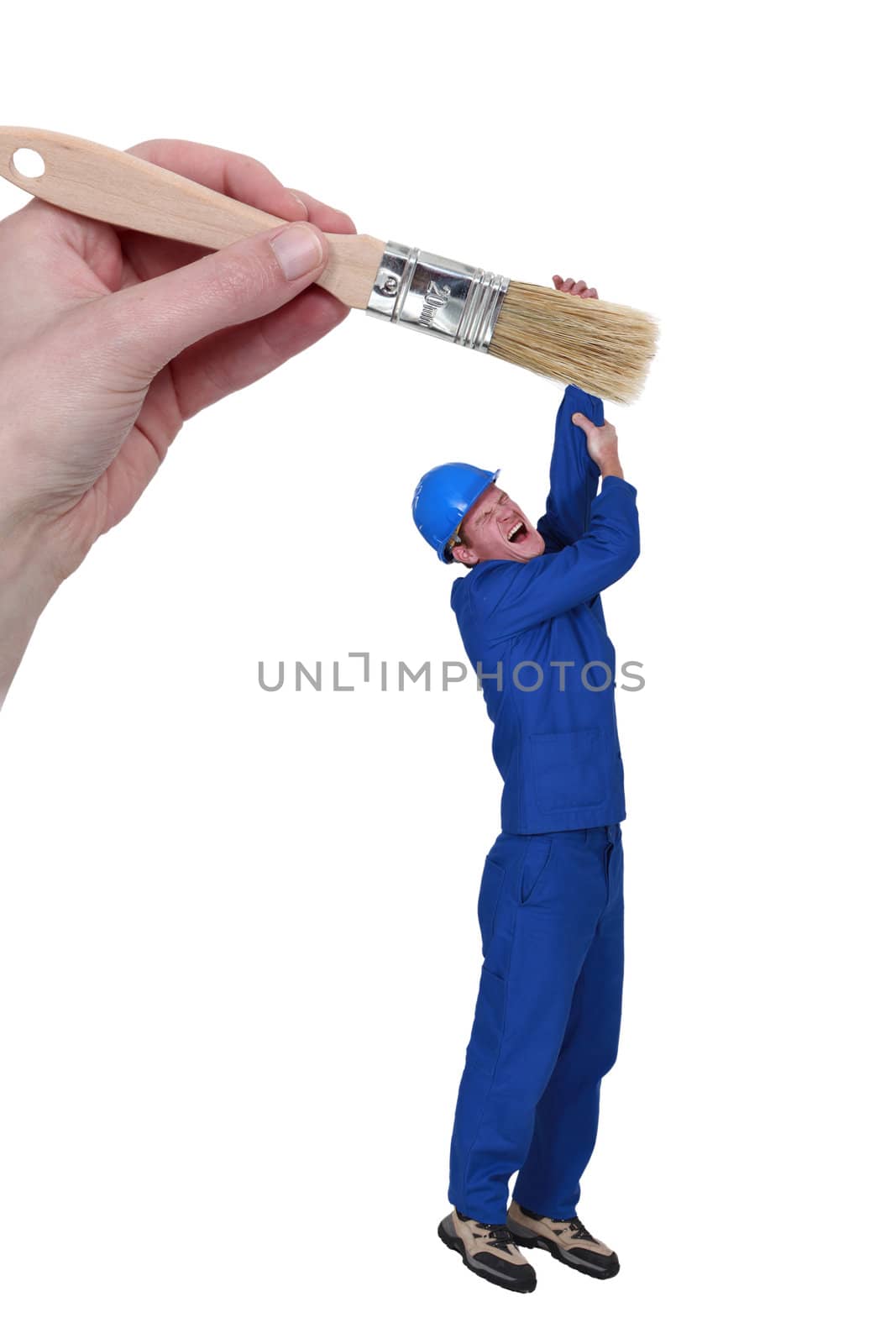 Man hanging from giant brush by phovoir