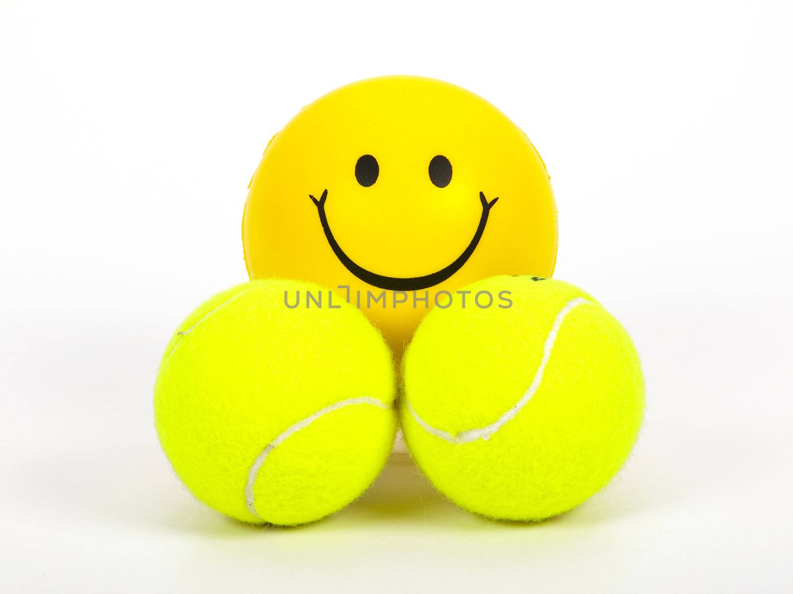 smiling tennis ball and two normal balls